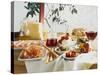 A Table Laid with Antipasti and Red Wine-Ulrike Koeb-Stretched Canvas