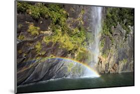 A Tall Waterfall Drops Off a Steep Cliff into Waters, Milford Sound on South Island, New Zealand-Paul Dymond-Mounted Photographic Print