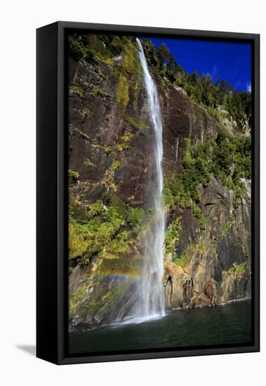 A Tall Waterfall Drops Off a Steep Cliff into Waters, Milford Sound on South Island, New Zealand-Paul Dymond-Framed Stretched Canvas