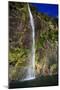 A Tall Waterfall Drops Off a Steep Cliff into Waters, Milford Sound on South Island, New Zealand-Paul Dymond-Mounted Photographic Print