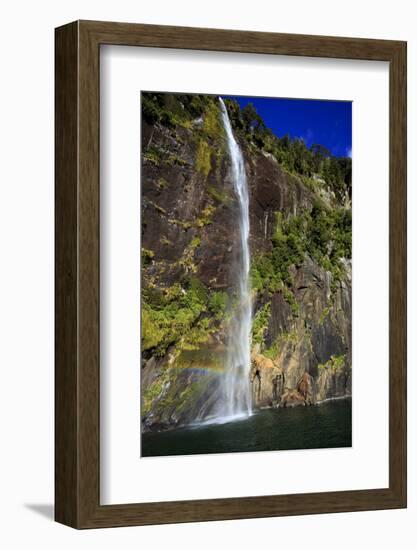 A Tall Waterfall Drops Off a Steep Cliff into Waters, Milford Sound on South Island, New Zealand-Paul Dymond-Framed Photographic Print