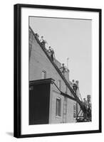 A Team of Firefighters With Hoses on Their Backs Climbs a Ladder-null-Framed Art Print