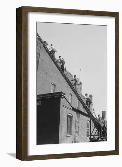 A Team of Firefighters With Hoses on Their Backs Climbs a Ladder-null-Framed Art Print