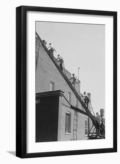 A Team of Firefighters With Hoses on Their Backs Climbs a Ladder-null-Framed Art Print