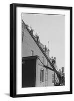 A Team of Firefighters With Hoses on Their Backs Climbs a Ladder-null-Framed Art Print