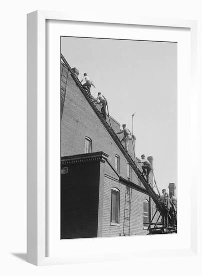A Team of Firefighters With Hoses on Their Backs Climbs a Ladder-null-Framed Art Print
