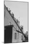 A Team of Firefighters With Hoses on Their Backs Climbs a Ladder-null-Mounted Art Print
