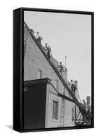 A Team of Firefighters With Hoses on Their Backs Climbs a Ladder-null-Framed Stretched Canvas
