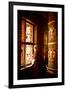 A Tibetan woman stands next to a large prayer wheel of the temple of Boudhanath Stupa, Kathmandu, N-Julian Bound-Framed Premium Photographic Print