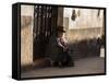 A Traditional Bolivian Woman Sits on a Doorstep in Potosi at Sunset-Alex Saberi-Framed Stretched Canvas