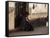 A Traditional Bolivian Woman Sits on a Doorstep in Potosi at Sunset-Alex Saberi-Framed Stretched Canvas