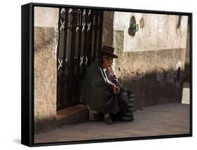 A Traditional Bolivian Woman Sits on a Doorstep in Potosi at Sunset-Alex Saberi-Framed Stretched Canvas