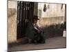 A Traditional Bolivian Woman Sits on a Doorstep in Potosi at Sunset-Alex Saberi-Mounted Premium Photographic Print