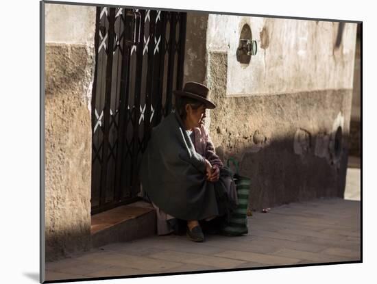 A Traditional Bolivian Woman Sits on a Doorstep in Potosi at Sunset-Alex Saberi-Mounted Photographic Print