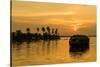 A traditional houseboat moves past the setting sun on the Kerala Backwaters, Kerala, India, Asia-Logan Brown-Stretched Canvas