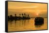 A traditional houseboat moves past the setting sun on the Kerala Backwaters, Kerala, India, Asia-Logan Brown-Framed Stretched Canvas