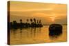 A traditional houseboat moves past the setting sun on the Kerala Backwaters, Kerala, India, Asia-Logan Brown-Stretched Canvas