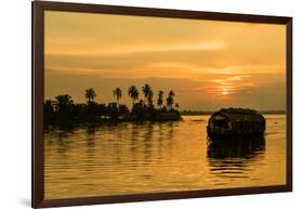 A traditional houseboat moves past the setting sun on the Kerala Backwaters, Kerala, India, Asia-Logan Brown-Framed Photographic Print