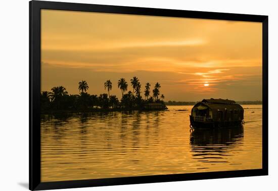 A traditional houseboat moves past the setting sun on the Kerala Backwaters, Kerala, India, Asia-Logan Brown-Framed Photographic Print