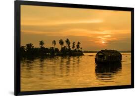 A traditional houseboat moves past the setting sun on the Kerala Backwaters, Kerala, India, Asia-Logan Brown-Framed Photographic Print