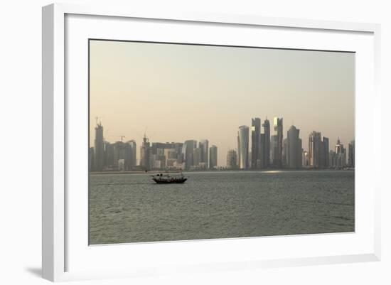 A Traditional Wooden Dhow Boat Sails Past Modern Skyscrapers, West Bay Financial District, Doha-Stuart Forster-Framed Photographic Print