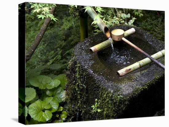 A Tsukubai With Bamboo Ladle in a Garden at Sanzenin Temple in Ohara, Kyoto, Japan-null-Stretched Canvas