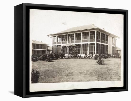 A Two-Story House Surrounded by Porches, with an American Flag Flying; in Panama During the…-Byron Company-Framed Stretched Canvas