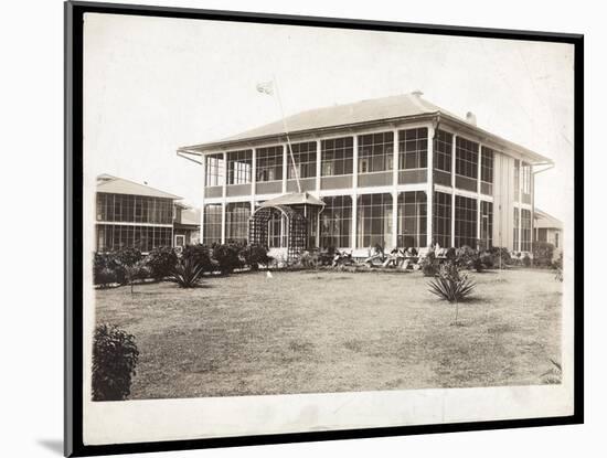 A Two-Story House Surrounded by Porches, with an American Flag Flying; in Panama During the…-Byron Company-Mounted Giclee Print