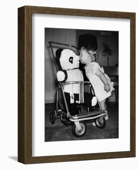 A Two Year Old Girl Kisses a Stuffed Panda on the Nose, Ca. 1955-null-Framed Photographic Print