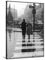 A Typical English Street on a Rainy Shopping Day: an Elderly Couple Use the Zebra Crossing-Henry Grant-Stretched Canvas