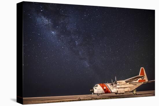 A U.S. Coast Guard C-130 Hercules Parked on the Tarmac on a Starry Night-null-Stretched Canvas