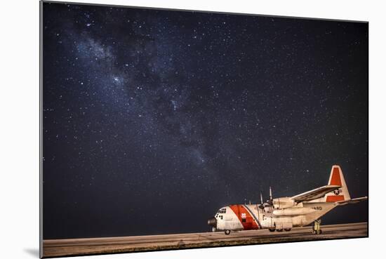 A U.S. Coast Guard C-130 Hercules Parked on the Tarmac on a Starry Night-null-Mounted Photographic Print