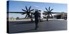 A U.S. Sailor Signals to a C-2A Greyhound Aircraft-null-Stretched Canvas