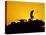 A U.S. Soldier Walks Atop His Armored Vehicle at Sunset-null-Stretched Canvas