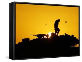 A U.S. Soldier Walks Atop His Armored Vehicle at Sunset-null-Framed Stretched Canvas