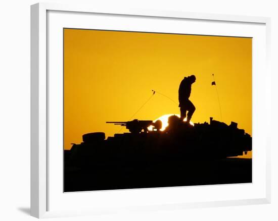 A U.S. Soldier Walks Atop His Armored Vehicle at Sunset-null-Framed Photographic Print