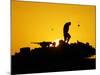 A U.S. Soldier Walks Atop His Armored Vehicle at Sunset-null-Mounted Photographic Print