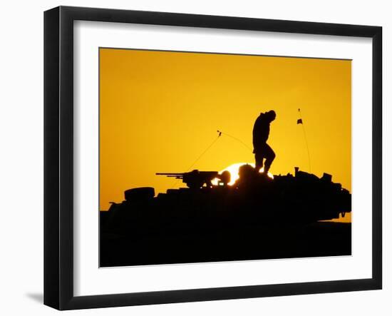 A U.S. Soldier Walks Atop His Armored Vehicle at Sunset-null-Framed Photographic Print