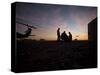 A UH-60 Black Hawk Crew Carry Out a Mission Brief at Sunset-null-Stretched Canvas