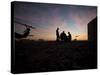 A UH-60 Black Hawk Crew Carry Out a Mission Brief at Sunset-null-Stretched Canvas