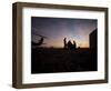 A UH-60 Black Hawk Crew Carry Out a Mission Brief at Sunset-null-Framed Photographic Print