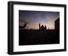 A UH-60 Black Hawk Crew Carry Out a Mission Brief at Sunset-null-Framed Photographic Print