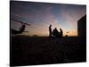 A UH-60 Black Hawk Crew Carry Out a Mission Brief at Sunset-null-Stretched Canvas
