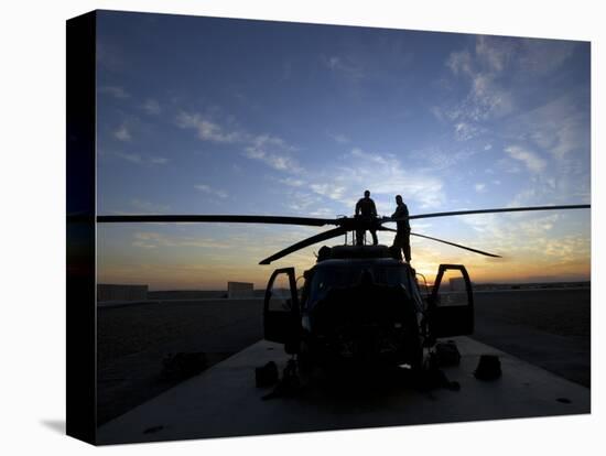 A UH-60 Black Hawk Helicopter on the Flight Line at Sunset-null-Stretched Canvas