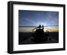 A UH-60 Black Hawk Helicopter on the Flight Line at Sunset-null-Framed Photographic Print