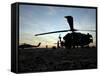 A UH-60 Black Hawk Helicopter on the Flight Line at Sunset-null-Framed Stretched Canvas