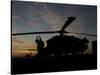 A UH-60 Black Hawk Helicopter on the Flight Line at Sunset-null-Stretched Canvas