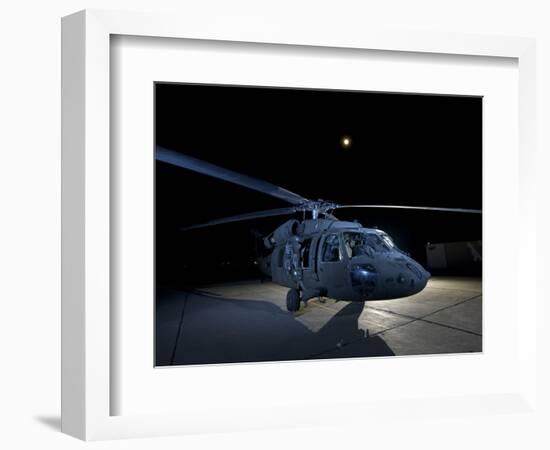 A UH-60 Black Hawk Helicopter Parked on the Flight Line under a Full Moon-null-Framed Photographic Print