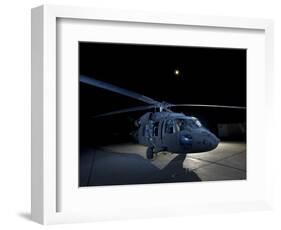 A UH-60 Black Hawk Helicopter Parked on the Flight Line under a Full Moon-null-Framed Photographic Print