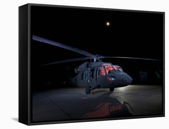 A UH-60 Black Hawk Helicopter Parked on the Flight Line under a Full Moon-null-Framed Stretched Canvas